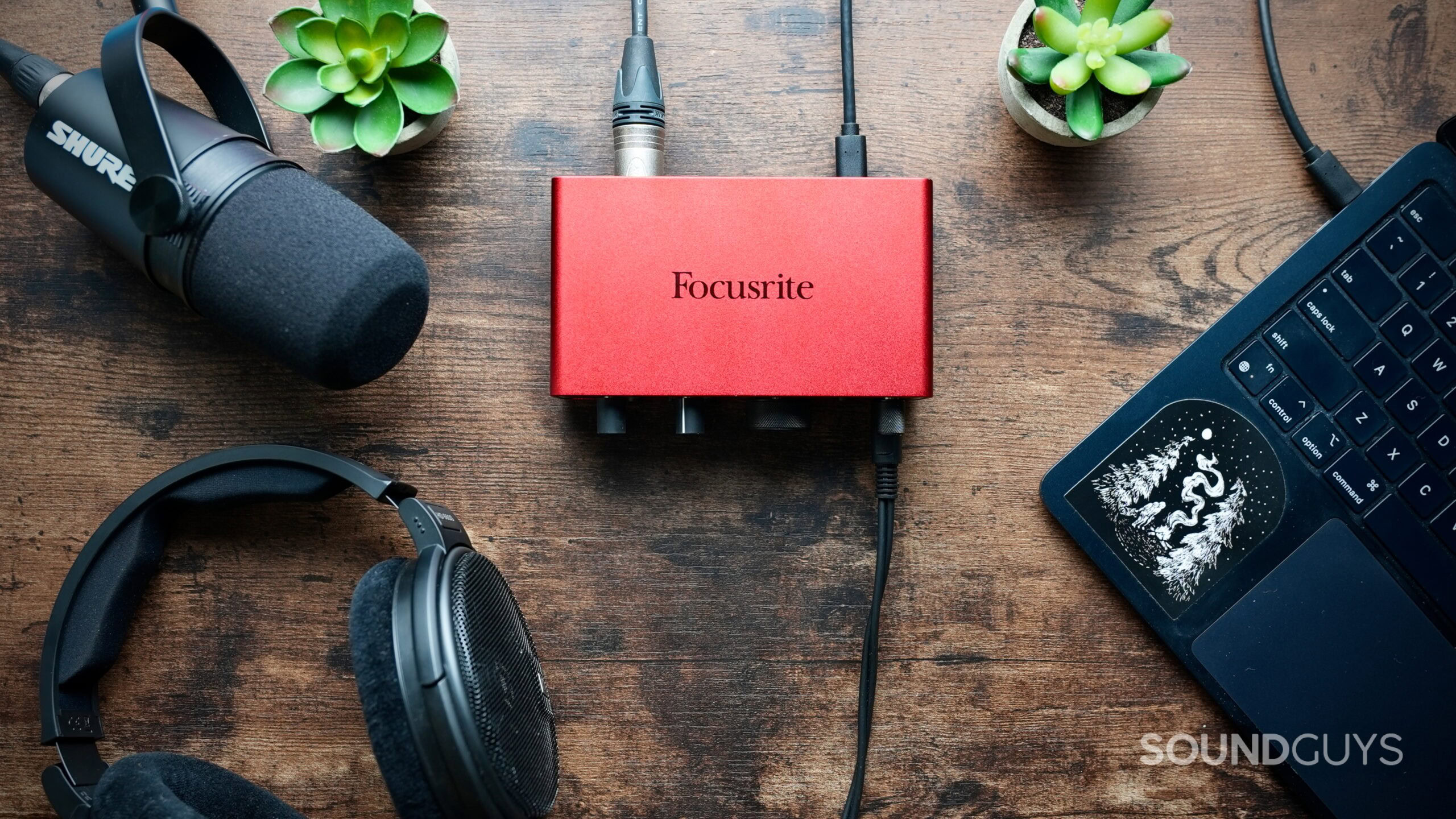 Don't buy a DAC - 1 Top down photo of a Focusrite Interface connected to a laptop, Sennheiser headphones, and a Shure mic.