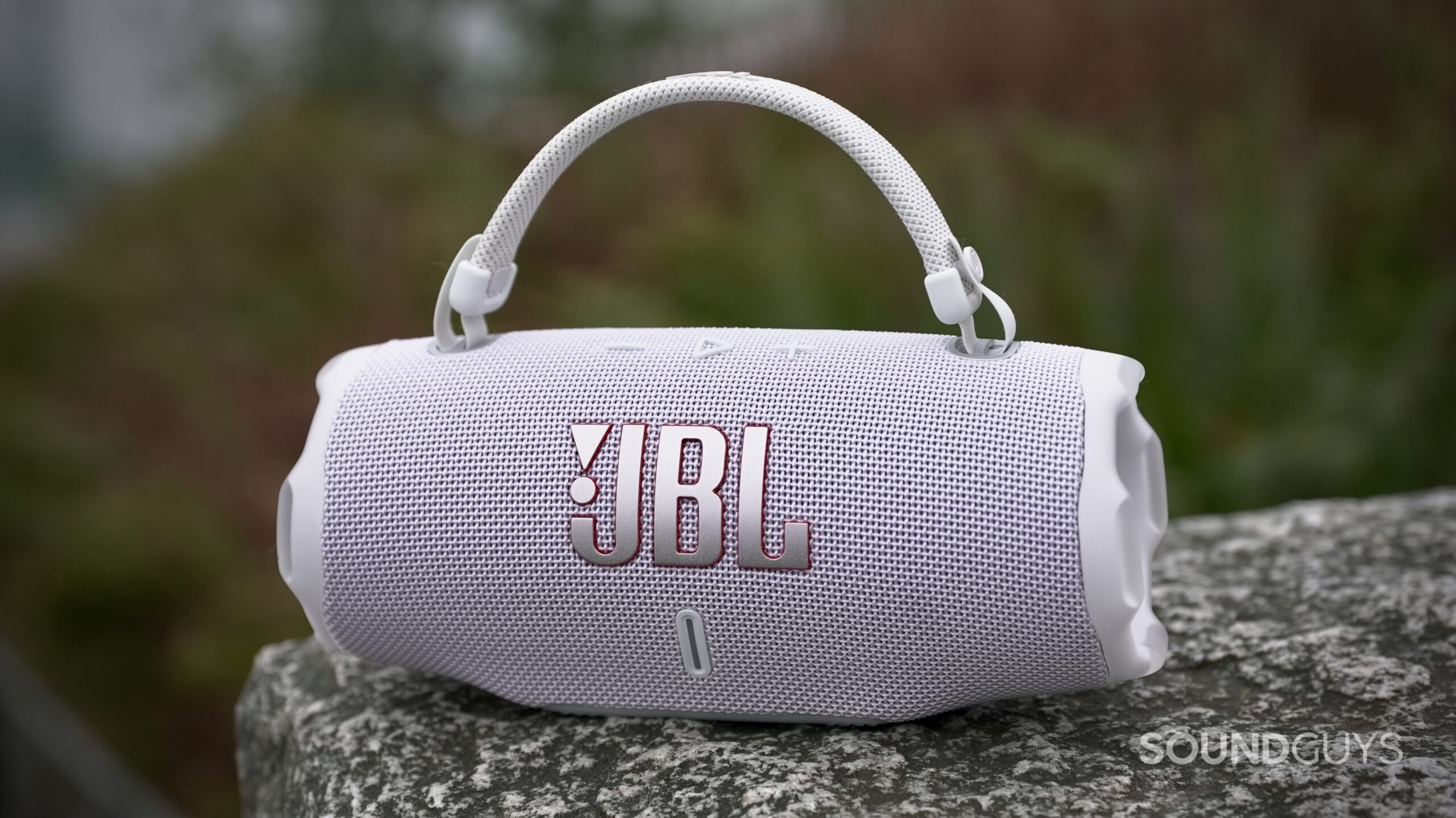 Charge 6 - 13 A nice photo of a JBL Charge 6 sitting on a rock.
