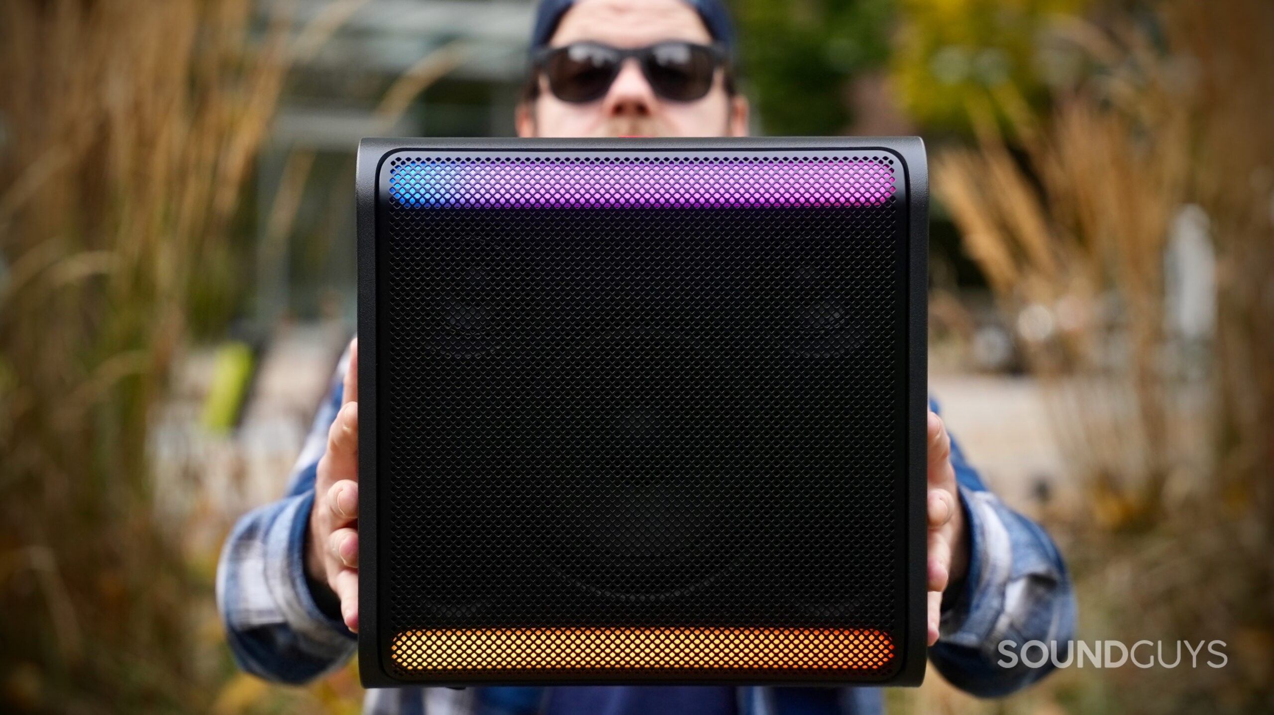 LG xboom Stage 301 - 6 A man holding the LG xboom Stage 301 by two hands in front of his body