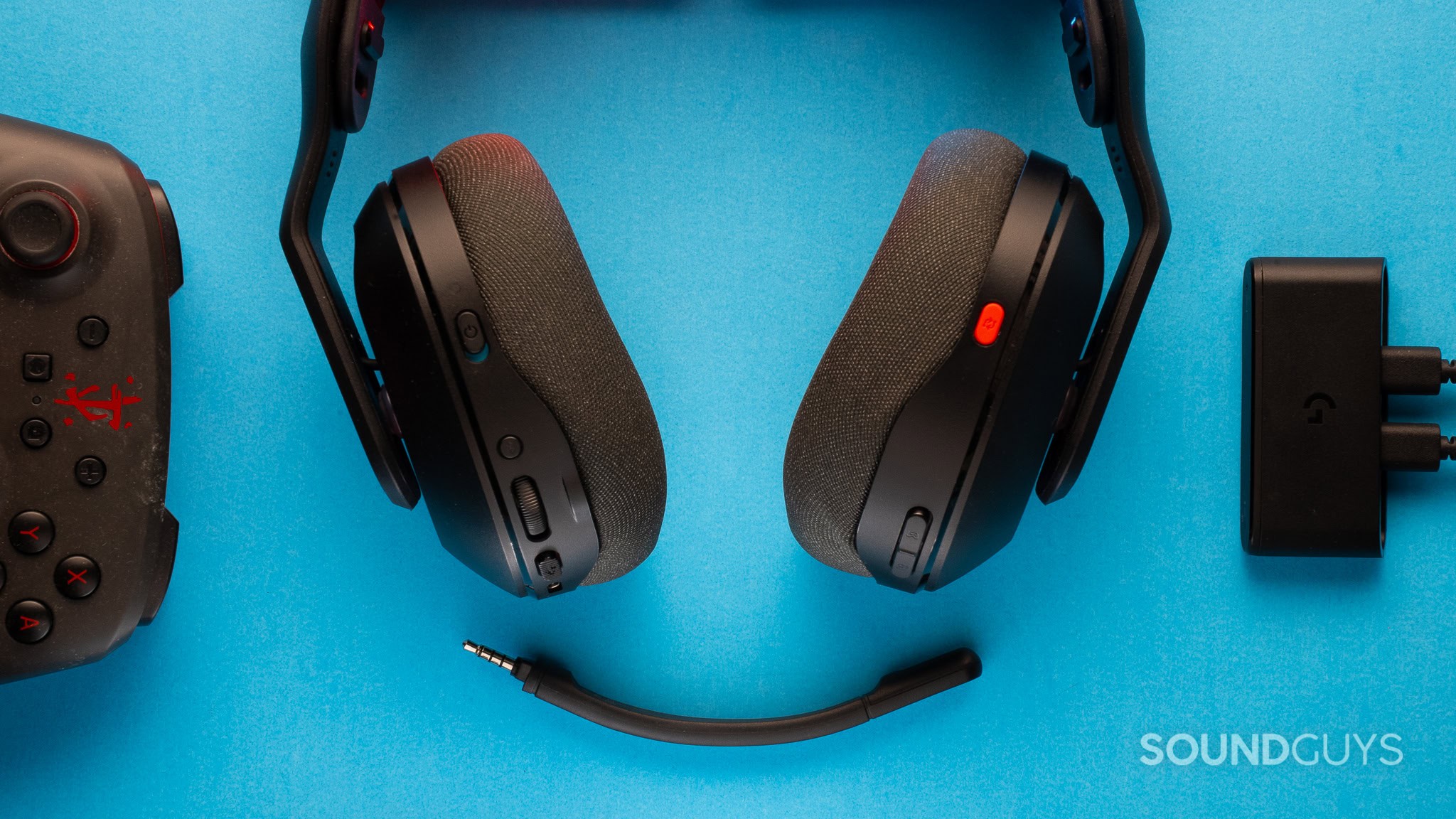 Top down of a Logitech A20 X with mic disconnected, with dock and controller flanking it.