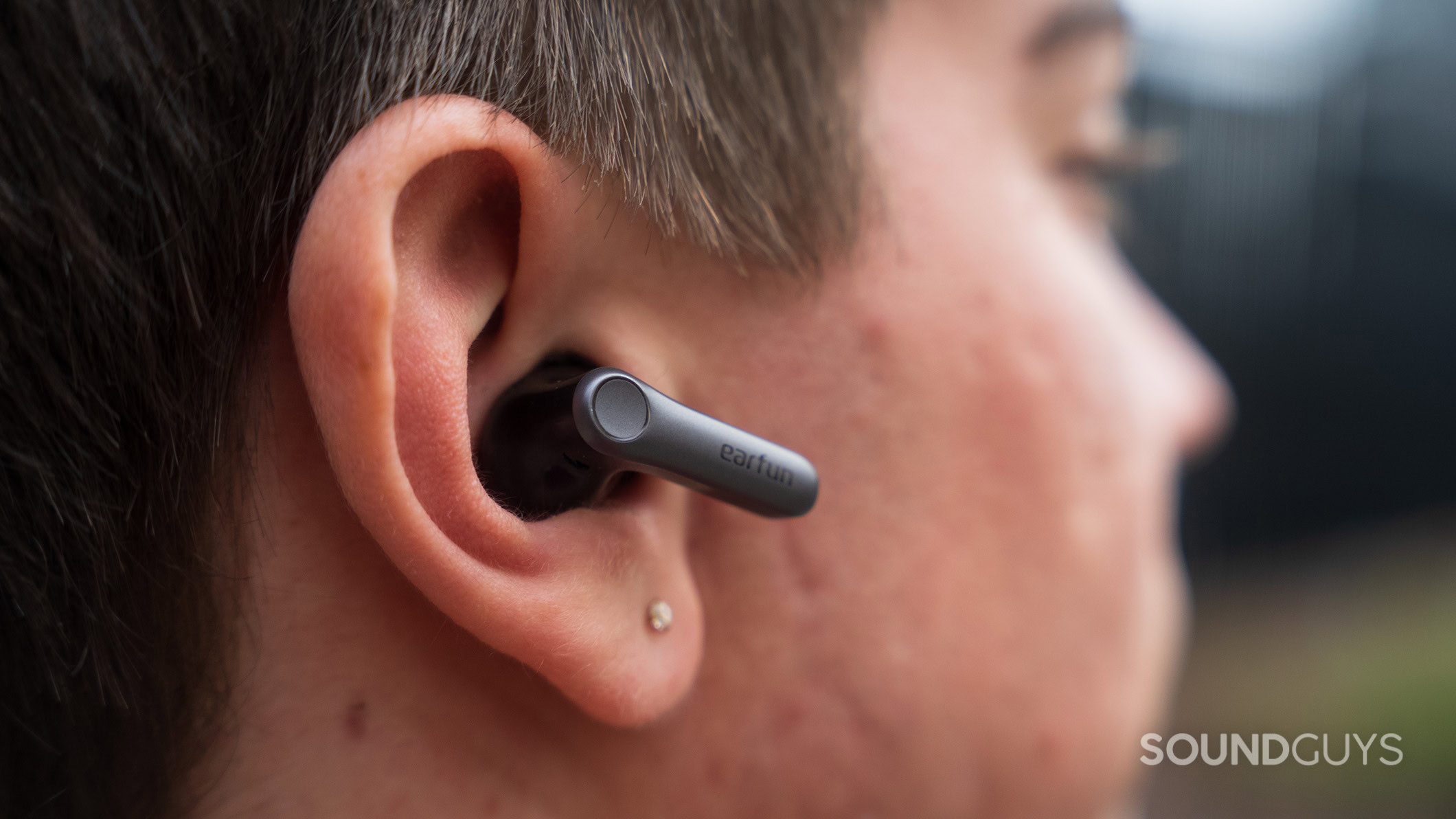 A man wearing the EarFun Air Pro 4 Plus earbuds.